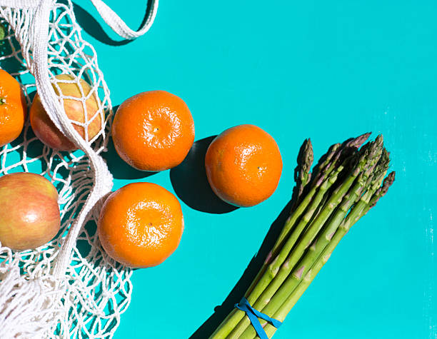 Net Shopping Bag, Mandarins  Apples Asparagus, Sunny Turquoise Background