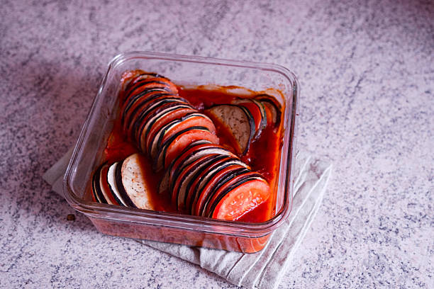 Homemade Ratatouille in Glass Baking Dish with Sliced Vegetables and Tomato Sauce