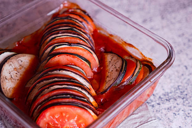 Homemade Ratatouille in Glass Baking Dish with Sliced Vegetables and Tomato Sauce