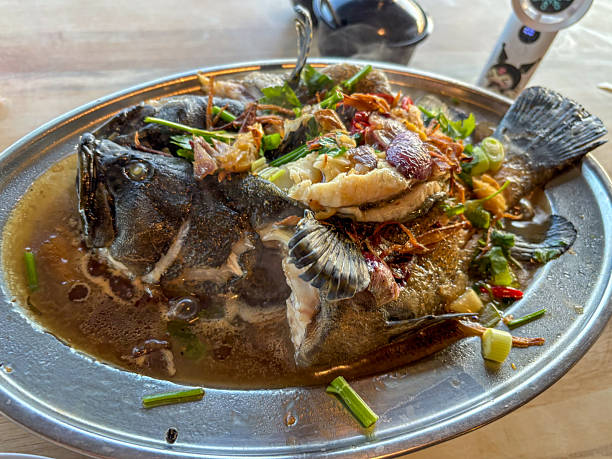 Whole fish served with herbs and spices in sauce