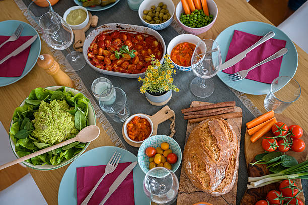 Top-down Shot of a Dining Table Brimming with Colorful Salads, Fresh Vegetables, and Homemade Bread