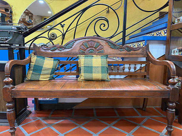 Rustic wooden bench with plaid cushions in a hacienda-style interior