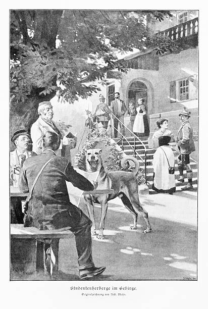 Authentic 19th-century black and white illustration depicting a lively genre scene at a student hostel in the mountains ('Studentenherberge im Gebirge'). Men are seated at a table under a tree, while others stand on the steps of the inn. A large, happy dog is a central, humorous figure. The scene captures a moment of leisure and social gathering in a traditional German or Alpine setting.