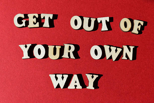 Get Out of Your Own Way, words in wooden alphabet letters on red background