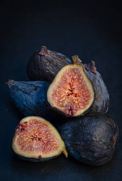 Ripe fresh figs on dark background