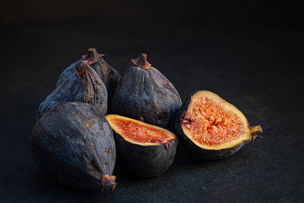 Ripe fresh figs on dark background