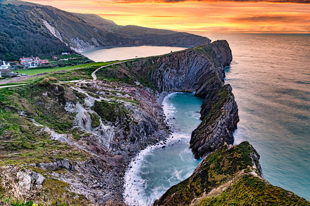 Stair Hole is a small cove located just west of Lulworth Cove in Dorset, southern England. The folded limestone strata known as the Lulworth crumple are particularly visible at Stair Hole.