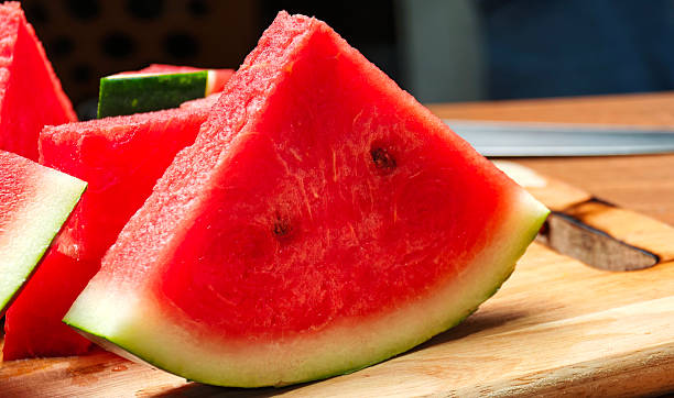 Slices of watermelon on a wooden board.
