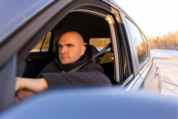 Man Driving Car in Daylight With Open Window