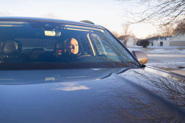 Man driving a car, looking focused straight ahead