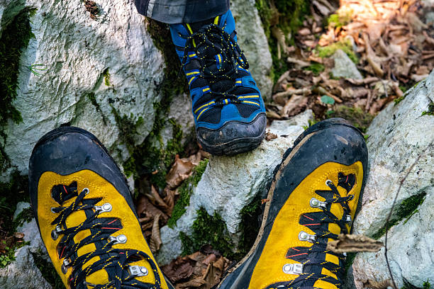 Two people hiking on rocky mountain trail