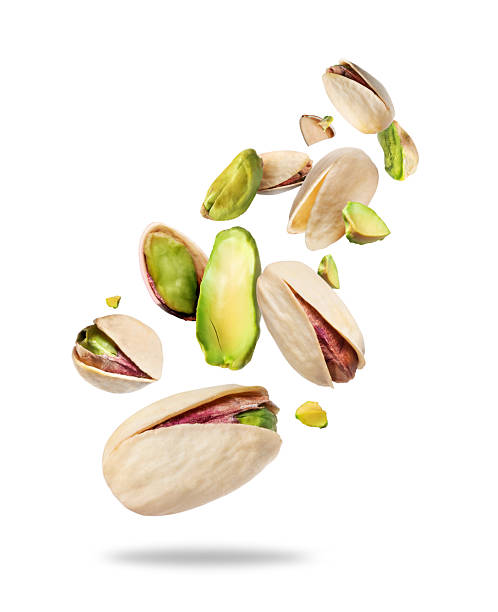 Opened pistachio nuts with kernels close-up isolated on a white background