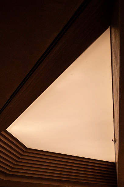 Warm light glows through triangular ceiling opening
