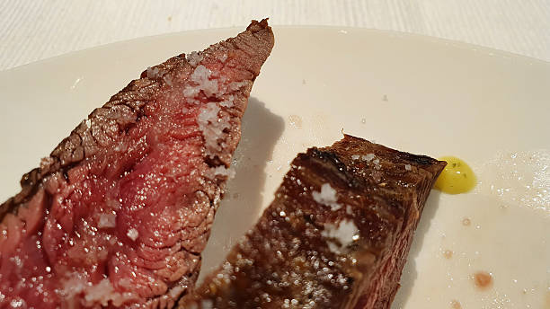 Close-up of perfectly cooked medium-rare steak seasoned with coarse sea salt
