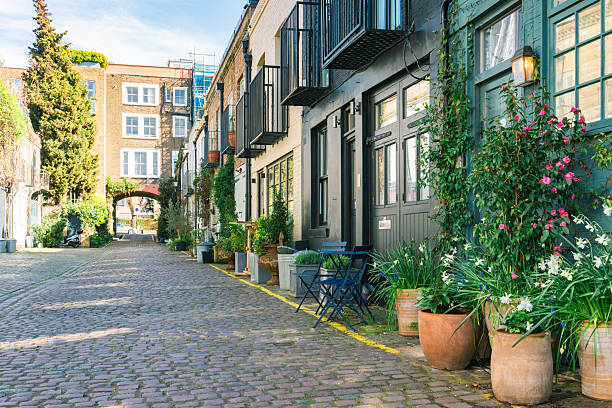 Notting hill mews street featuring cobblestones and blue outdoor furniture