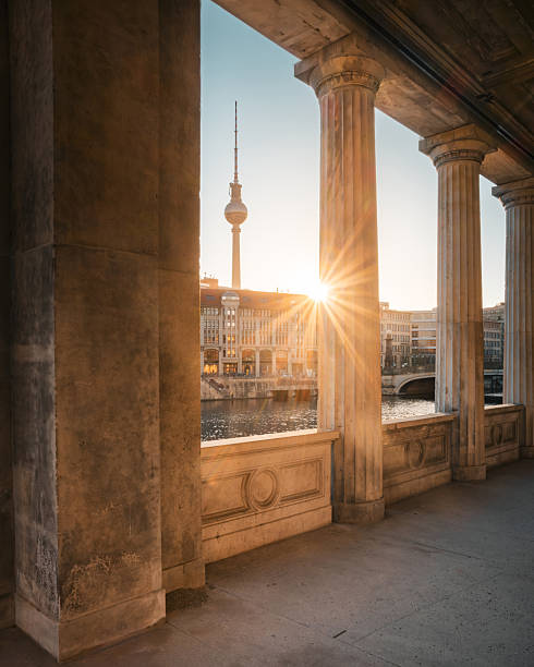 Golden Sunrise Through Historic Columns with TV Tower View