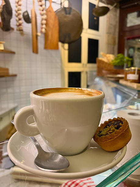 Cappuccino with pastry on a cafe counter in Volterra, Italy