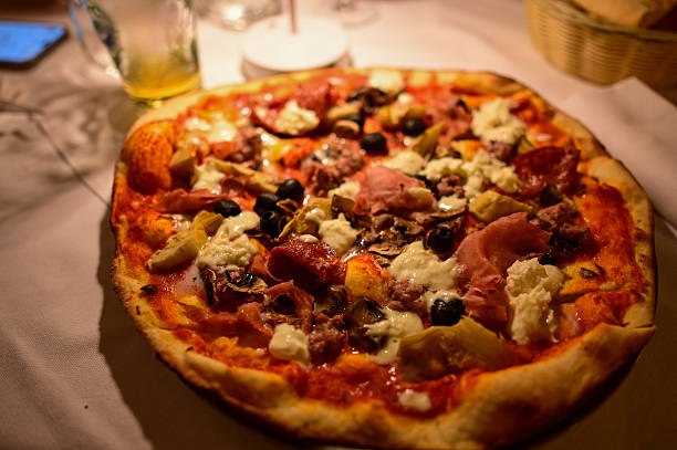 Delicious meat and vegetable pizza at restaurant dinner table