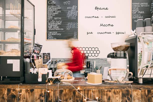 A busy cafe scene with a barista preparing coffee. . The cafe has a warm, inviting atmosphere. Busy barista, blurred in motion