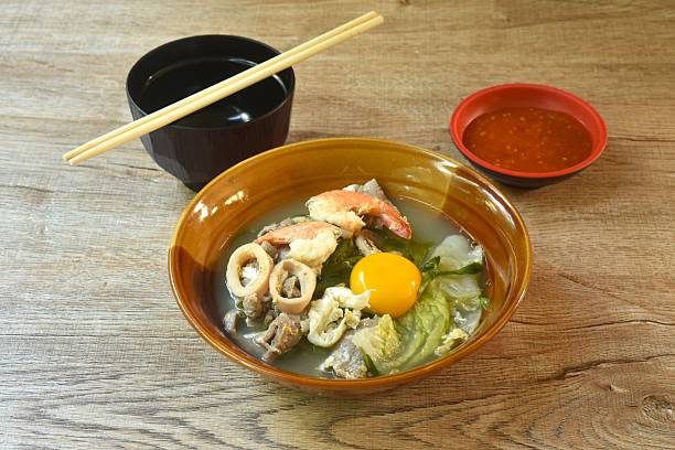 boiled sukiyaki seafood chicken and pork meat couple squid and shrimp with vegetable in soup dipping sauce