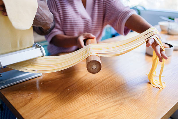 Couple Making Homemade Pasta Together In Kitchen