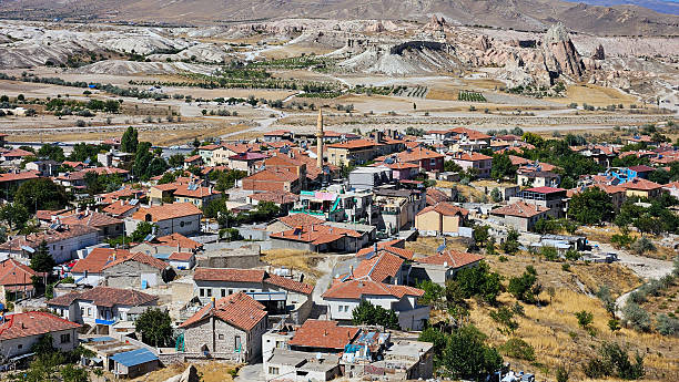 Sunlit Stone Village With Red Roofs, Winding Streets And Rocky Plateau Backdrop Panoramic Aerial Perspective Capturing Terracotta Settlement, Dry