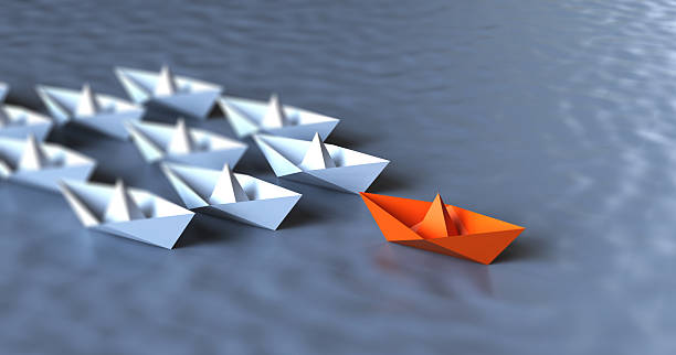 Paper boat and leadership concept