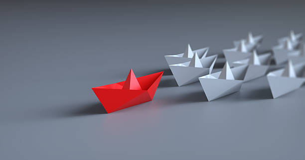 Paper boat and leadership concept
