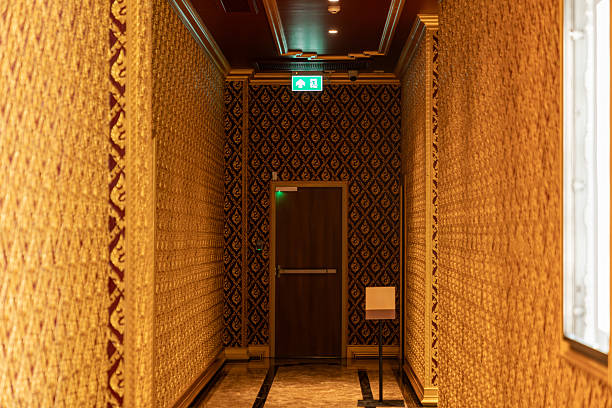 Corridor leading to emergency exit door with signage representing safety and building navigation.
