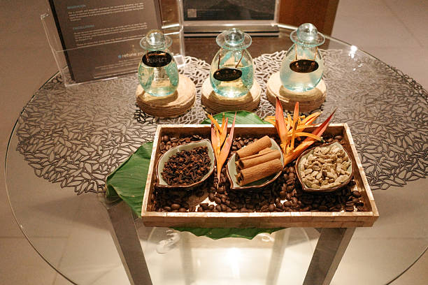 Glass table holds three glass jars with dark liquid