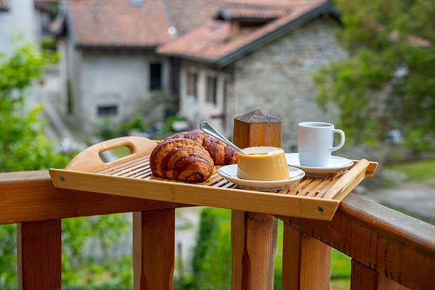 breakfast with creamy pudding panna cotta, fresh croissants, and coffee, Italian Morning, rustic village from balcony, Authentic Italian Charm