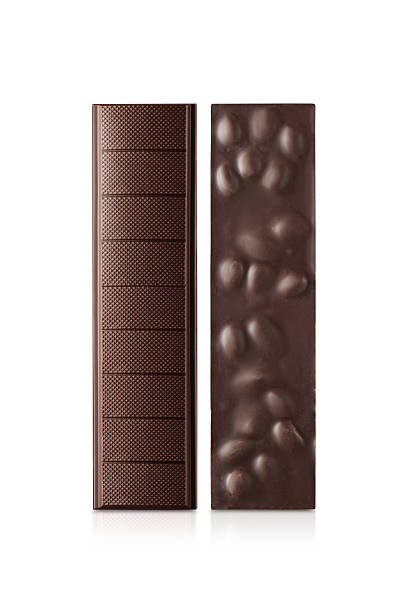 : Two milk chocolate bars with whole hazelnuts isolated on white.