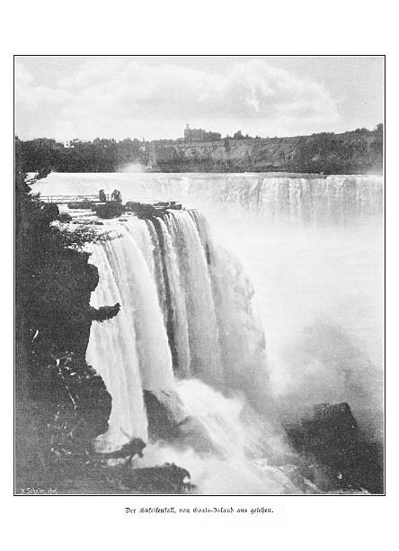 Authentic 19th-century black and white print showing the Horseshoe Falls, part of Niagara Falls, as seen from Goat Island. A few tourists stand on a viewing platform at the precipice, with the Canadian side visible in the background. The German caption reads 'Der Hufeisenfall, von Goats-Island aus gesehen.'