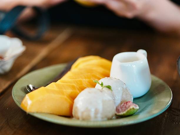 Mango slices served with coconut ice cream