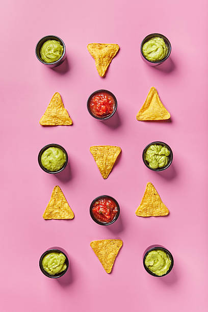 Nachos corn chips with sauce, salsa and guacamole on color background. Mexican cuisine concept