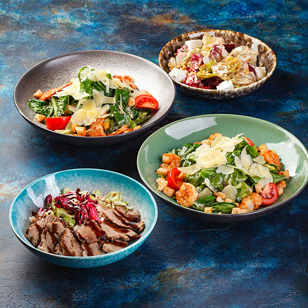 Bowls filled with different types of food, including various vegetable salads