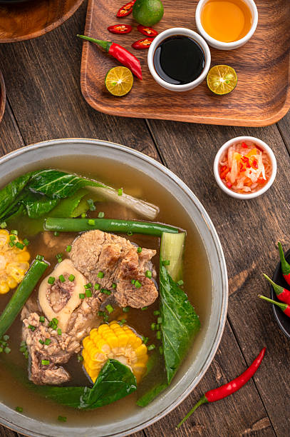 Beef bulalo with bone in beef shank soup on wooden background