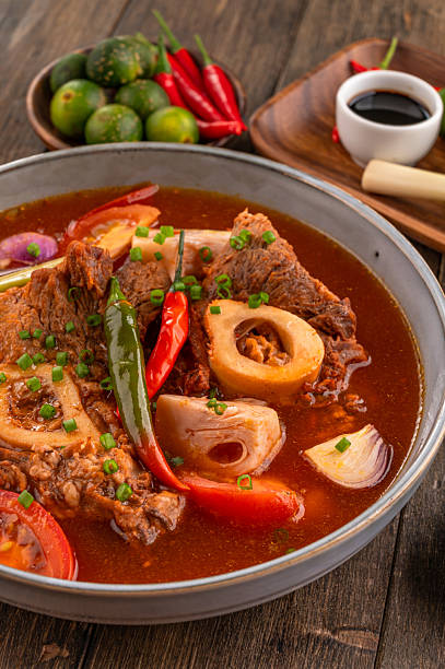 Kansi beef shank sour soup with bone marrow on wooden background