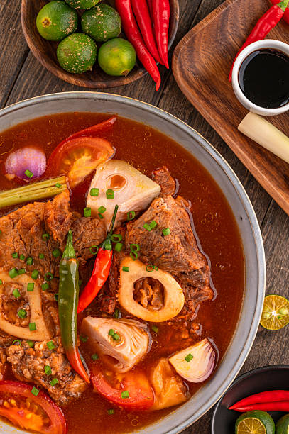 Kansi beef shank sour soup with bone marrow on wooden background