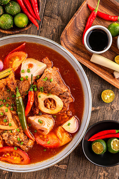 Kansi beef shank sour soup with bone marrow on wooden background