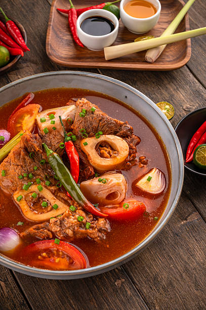 Kansi beef shank sour soup with bone marrow on wooden background