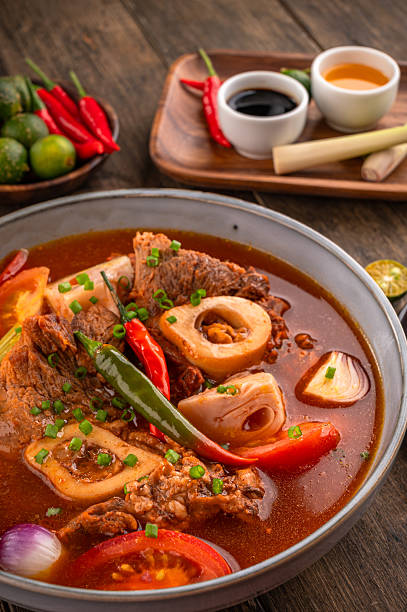 Kansi beef shank sour soup with bone marrow on wooden background
