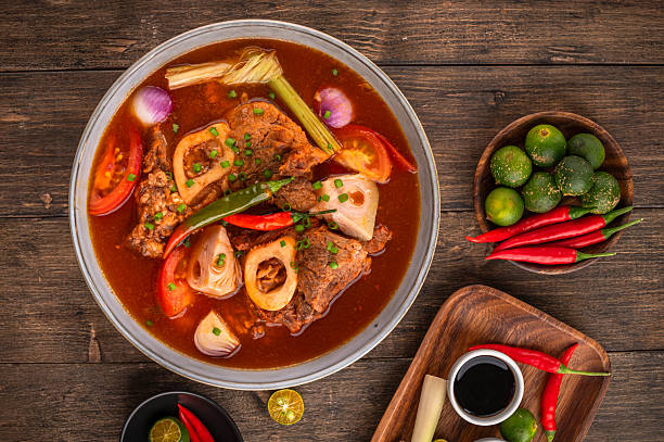 Kansi beef shank sour soup with bone marrow on wooden background
