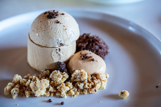Espresso parfait served on a white plate with a crumb topping, mocha mousse, and chocolate crumble, offering a delightful and gourmet culinary experience