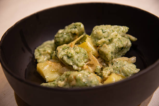 Gnocchi de la cua. Ripe green and black olive tree fruit on a branch. Harvest time.