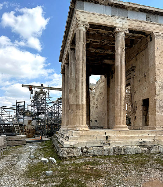 close up of the North Porch of the Erechtheion temple with fluted Ionic columns, the extensive scaffolding and construction equipment used for the ongoing  restoration ,  is in the background, the Acropolis, Athens