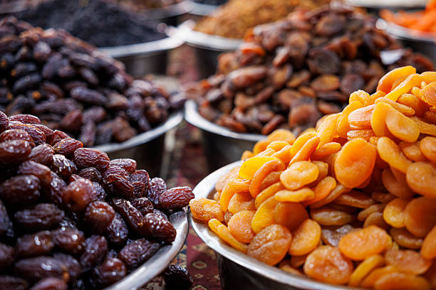 Dried apricots and dates displayed at traditional market