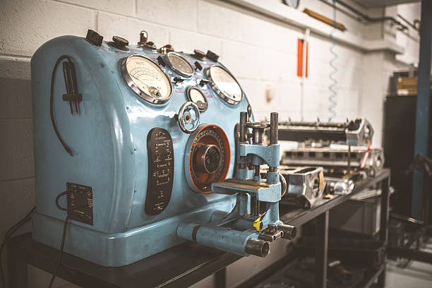 A detailed view of an old-fashioned blue electrical testing apparatus featuring multiple analog meters and various switches for diagnostics
