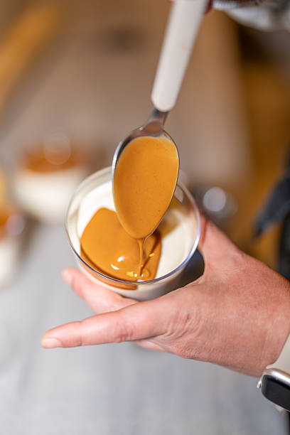 Pouring Biscuit Cream Sauce Over Magnolia Dessert Close-Up