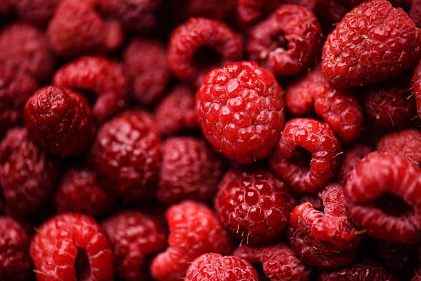Close-Up of Raspberry Surface With Fuzzy Texture and Juicy Red Flesh